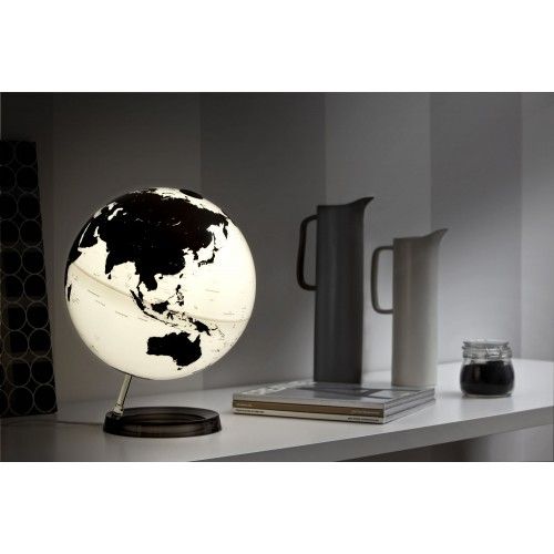 Globo terrestre luminoso blanco negro en la base negra