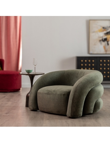 Room view : green fabric armchair with curved buttoned backrest