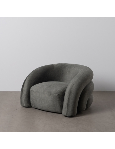 Détail : Fauteuil de salon vert en tissu, dossier capitonné incurvé